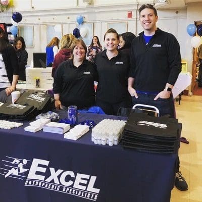 Excel team members at a booth at the Stoneham Fair 2019